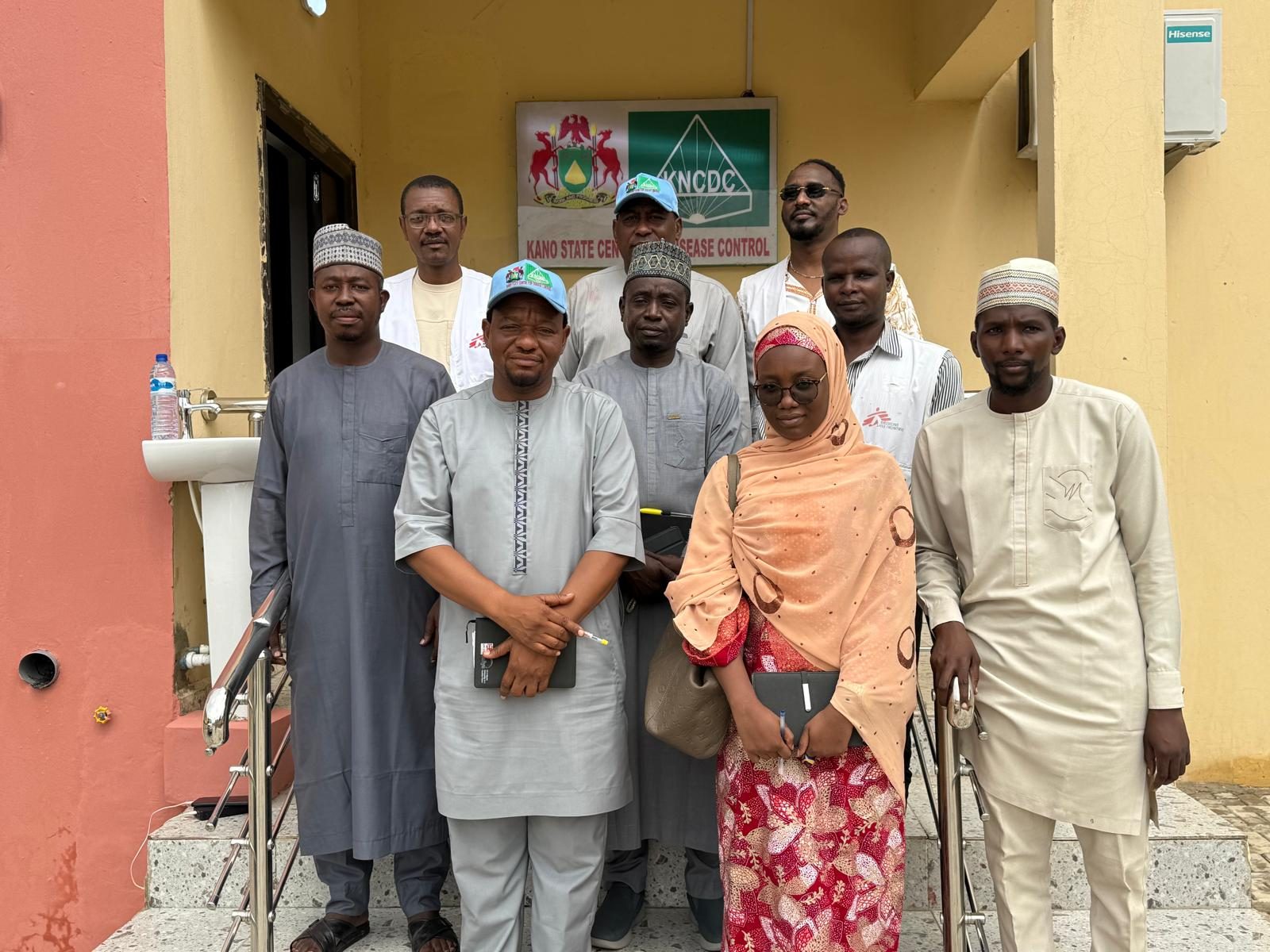 With colleagues at a clinic entrance