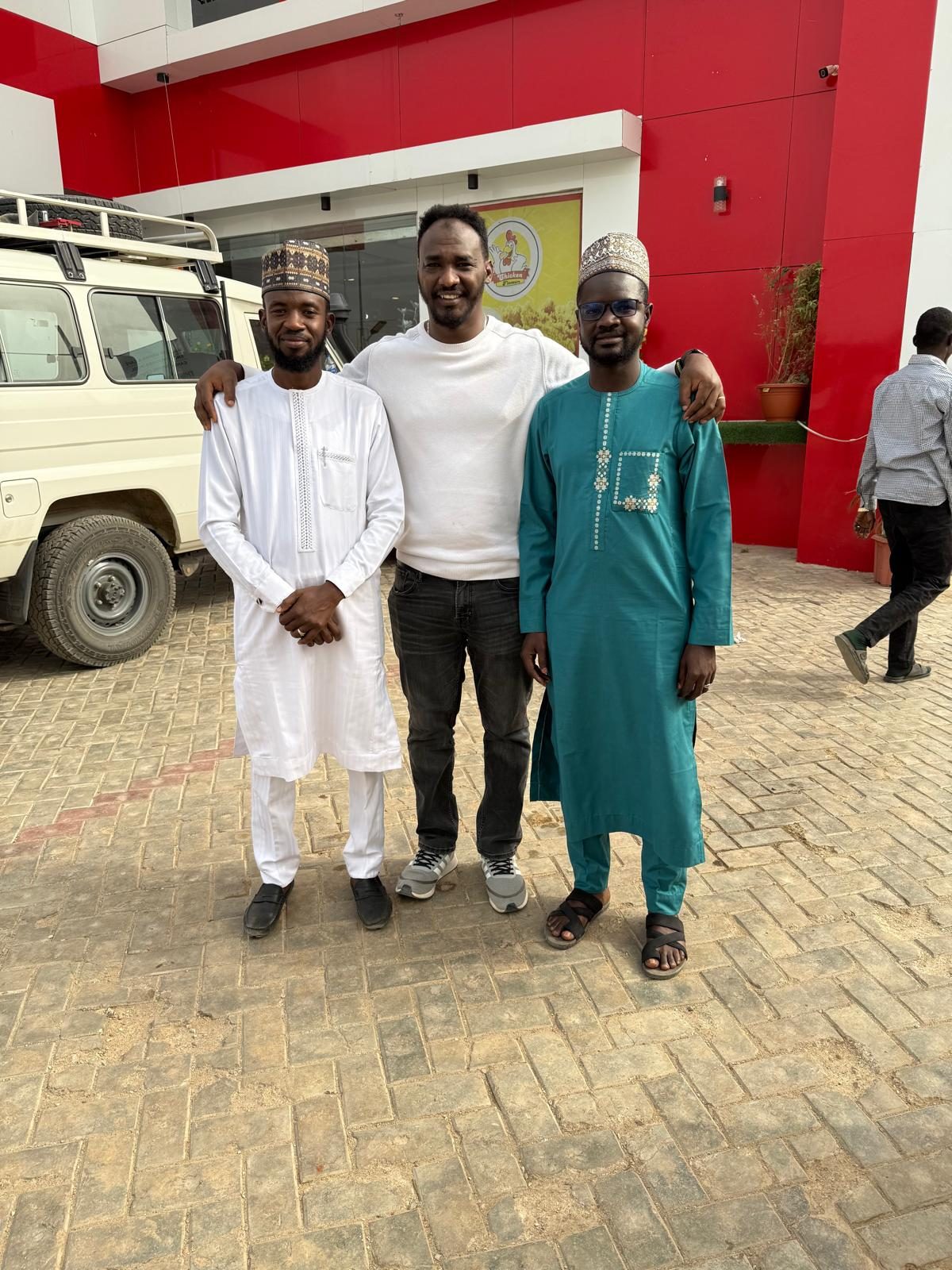 With colleagues in front of a facility