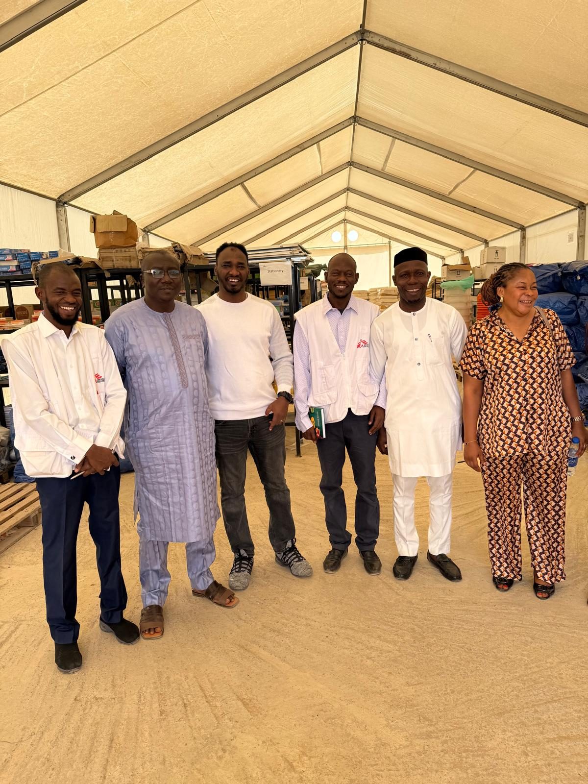Group photograph in an open-sided marquee