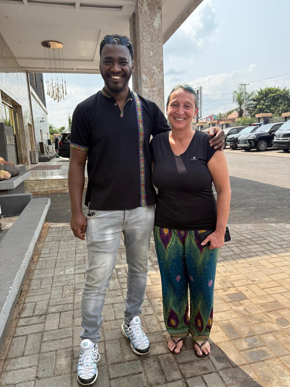 With a colleague at a facility entrance