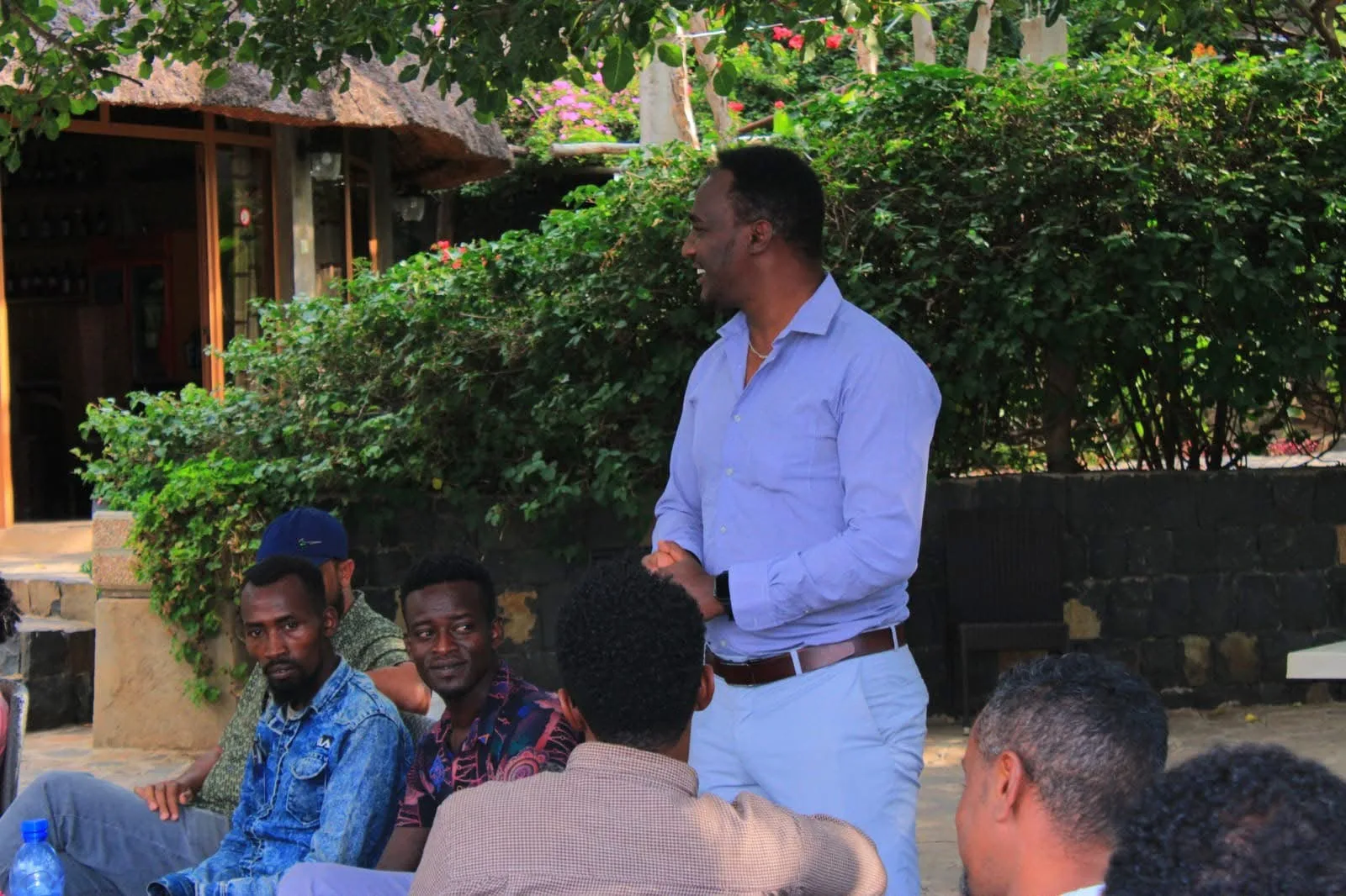 Addressing colleagues at an outdoor gathering
